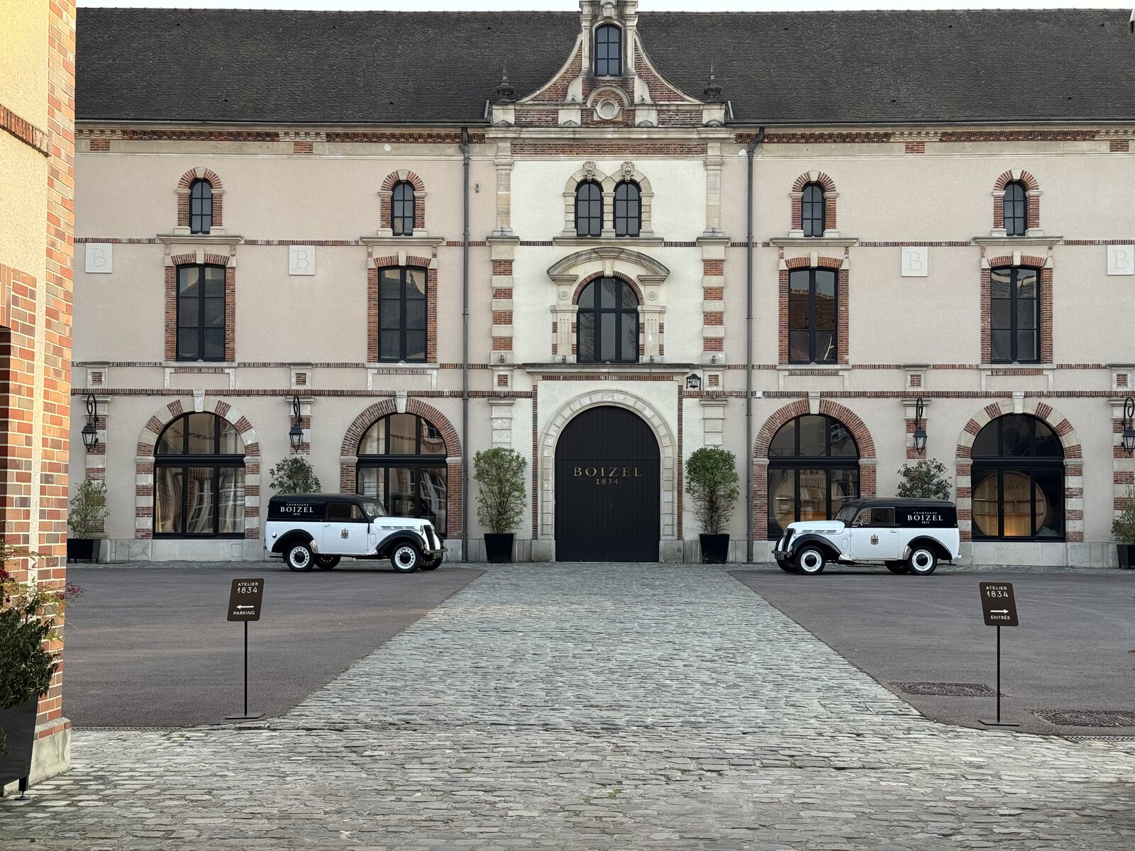 Boizel courtyard with vintage delivery cars